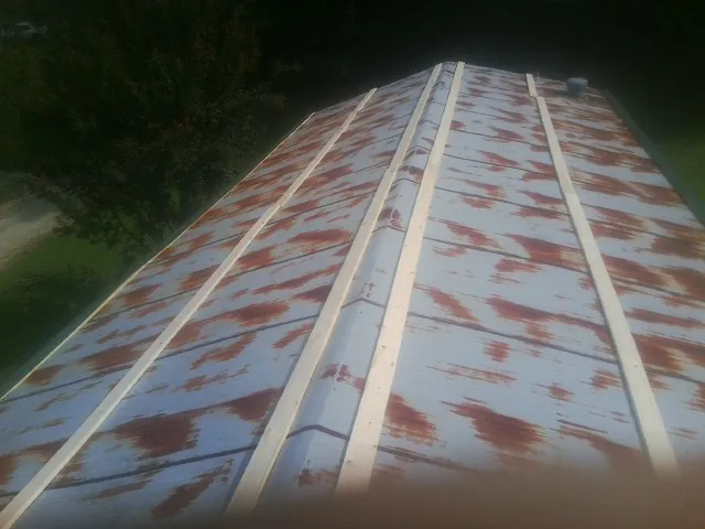Rusted metal roof panels with new wood purlins before replacement — Storm Damage Roof Repair in Saddle River by Roofing Brothers