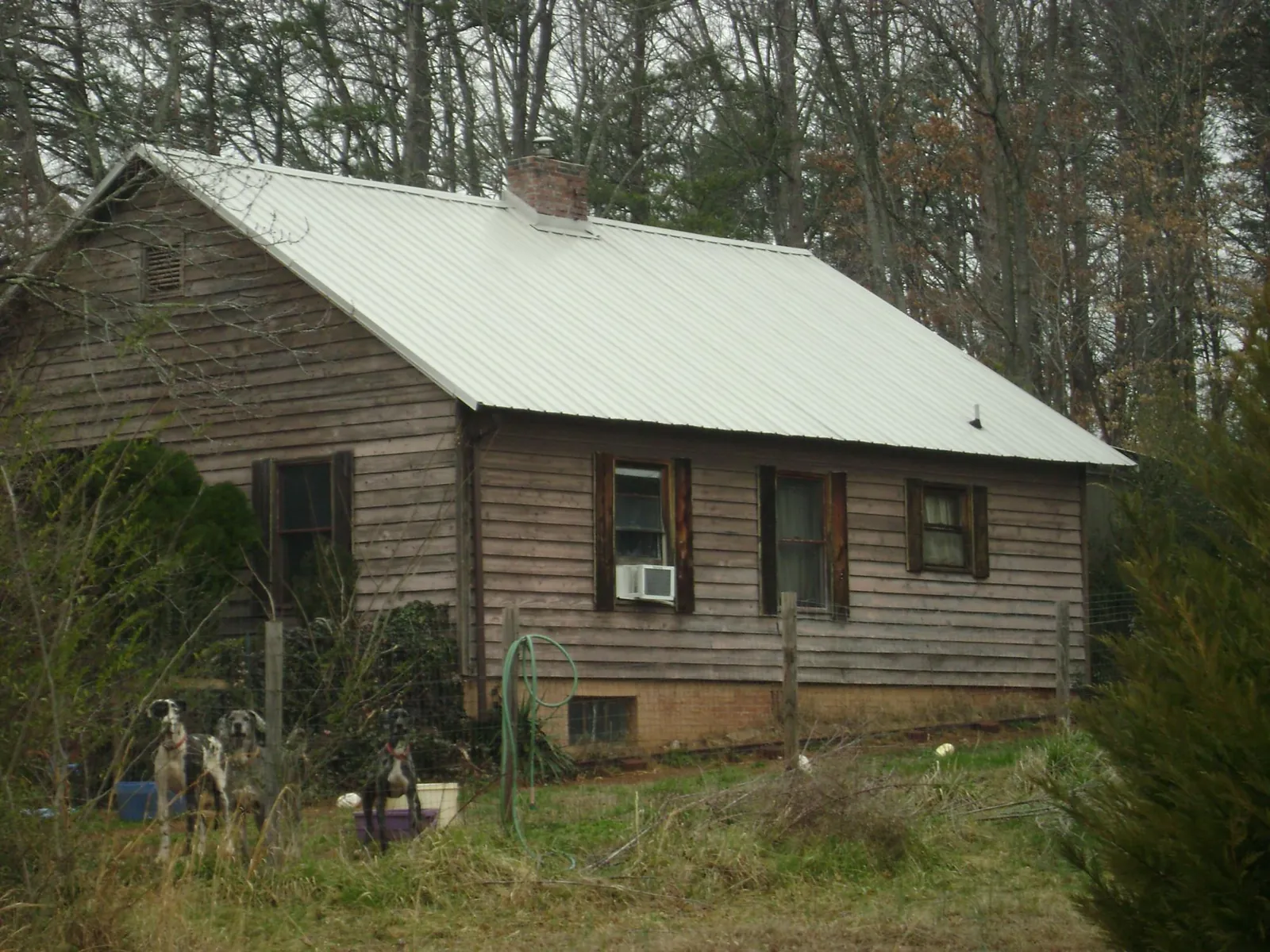 White metal roof on an old wood sided farmhouse, from a Metal Roof Installation job in Saddle River